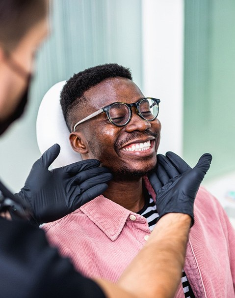 A man smiling at the dentist