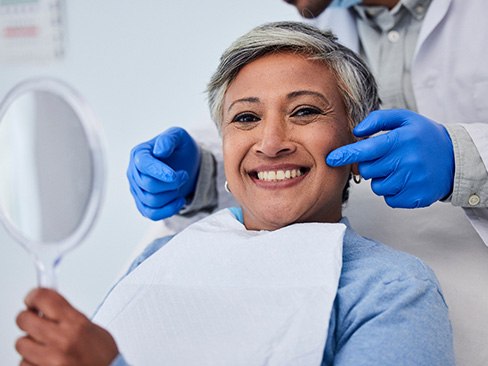 A woman smiling at the dentist