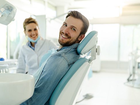 Man smiling while relaxing in treatment chair
